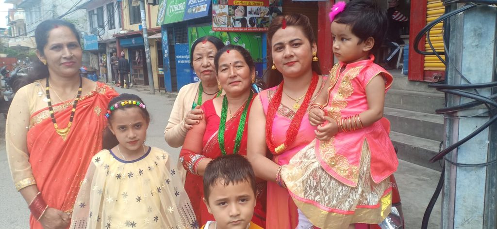 : Nepali women and children wearing traditional clothes during Teej celebration
