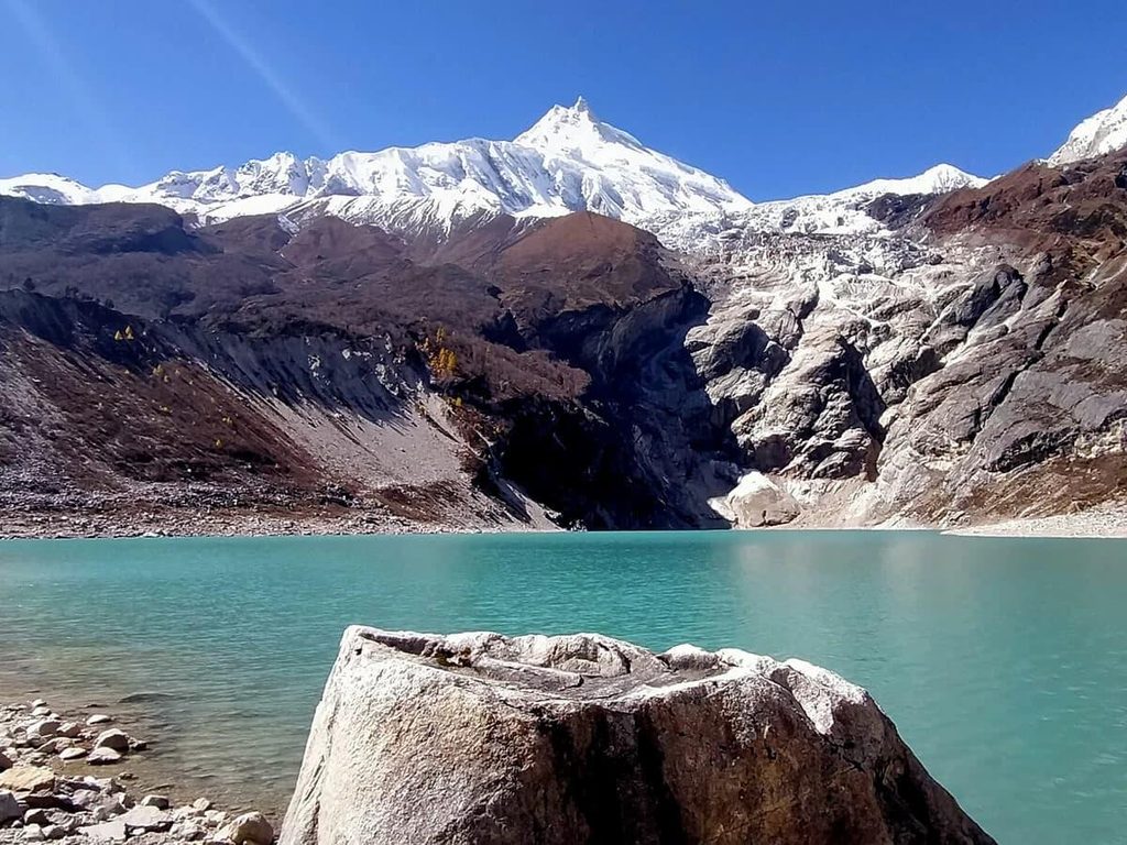 Ponkar Glacial Lake surrounded by the Himalayas in Nepal
