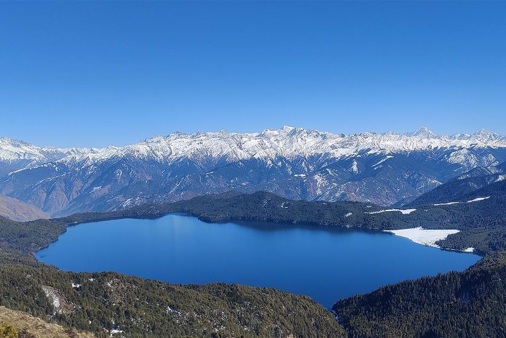 Rara Lake surrounded by lush green hills and Himalayan landscapes in Nepal